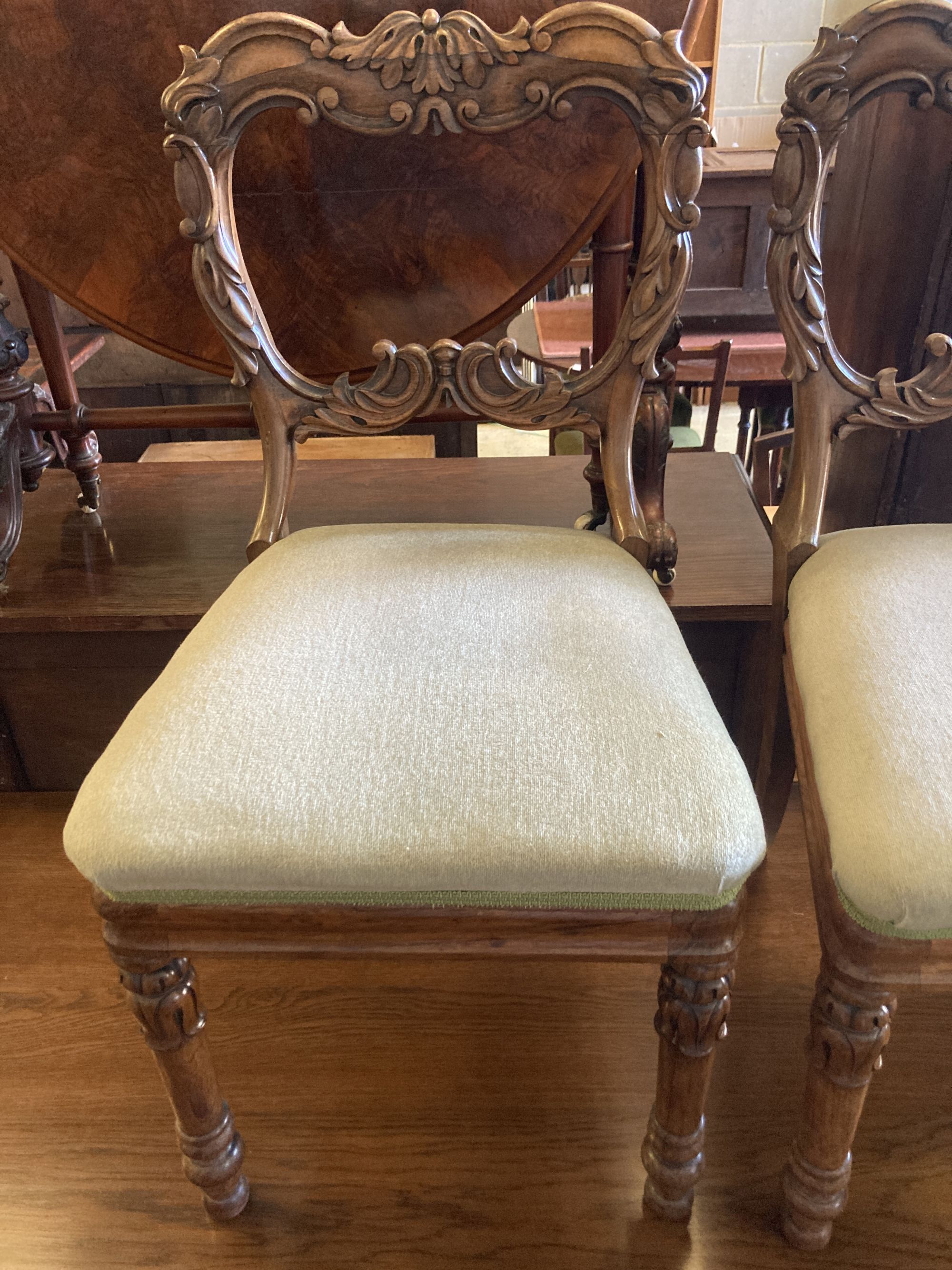 A set of four early Victorian carved rosewood dining chairs